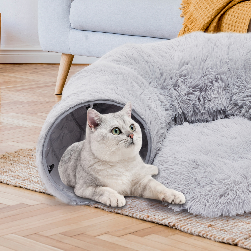 Cat inside plush donut cave tunnel bed