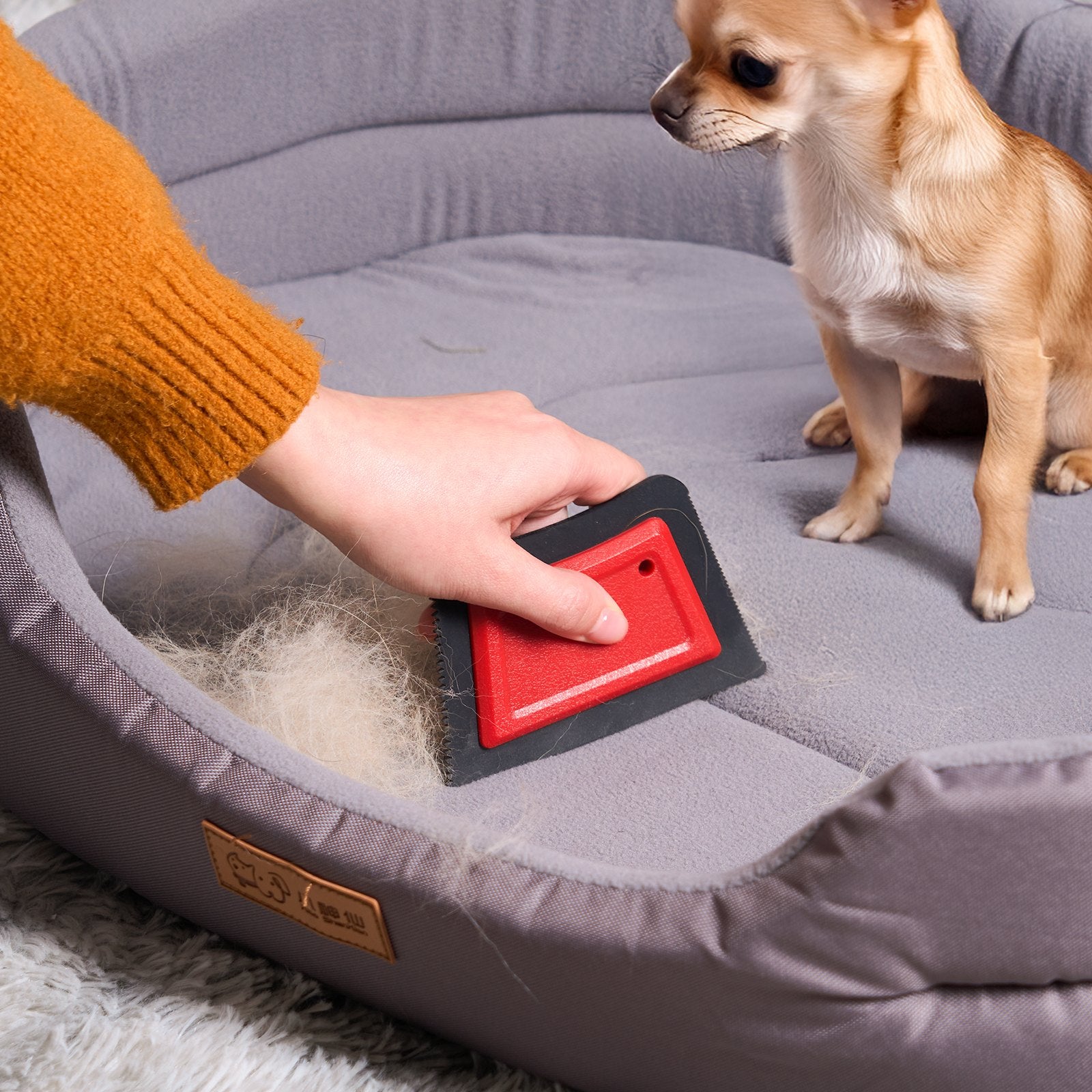 Pet hair remover in use on couch